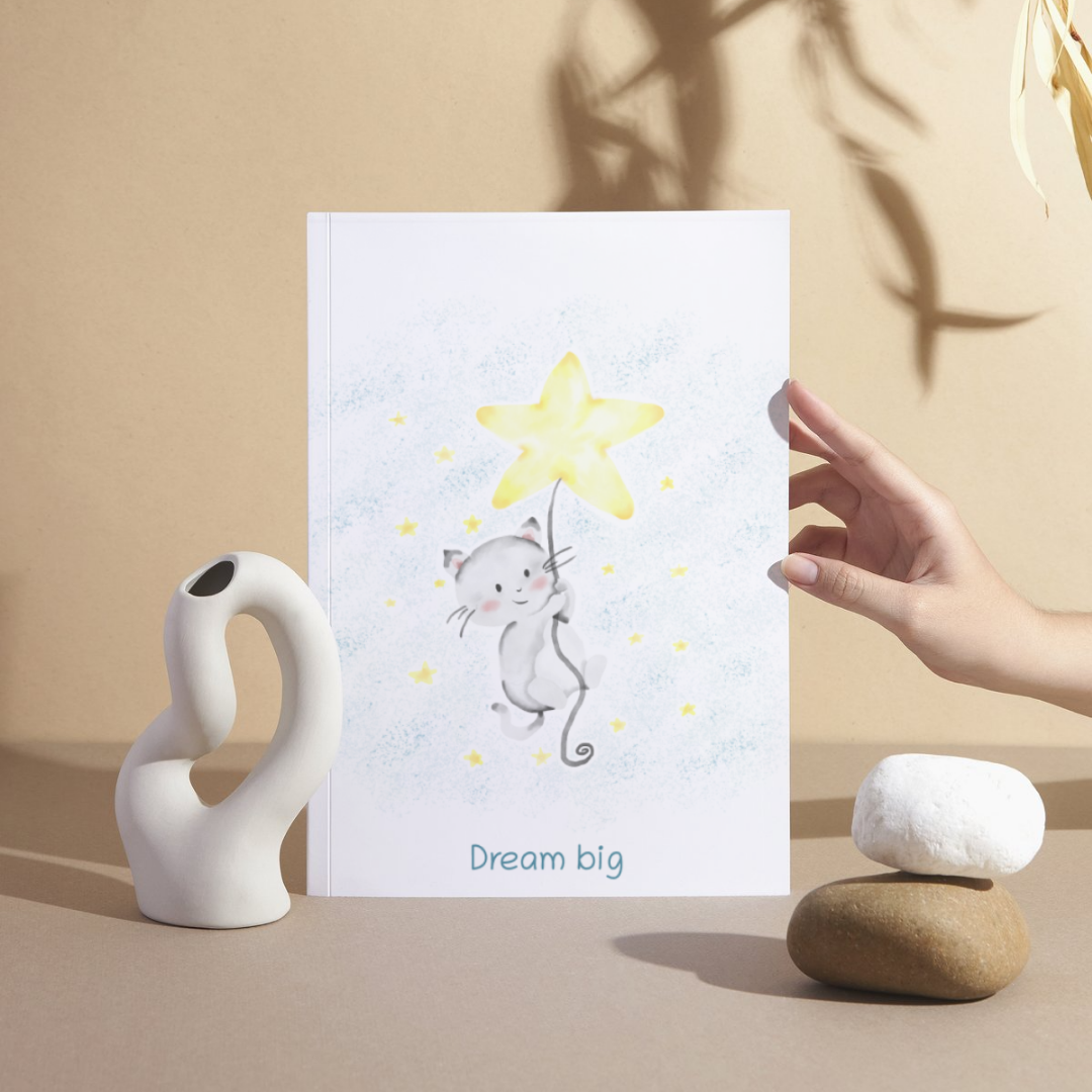 Hand holding a card with a cat and star illustration on a beige background
